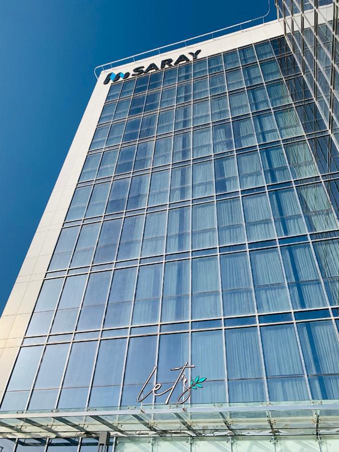 Saray Deluxe Hotel Apartments Abu Dhabi Buitenkant foto The glass facade of the building